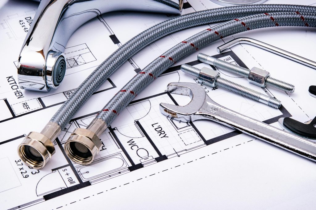 homeowner comparing plumbing quotes from different plumbers for repair work