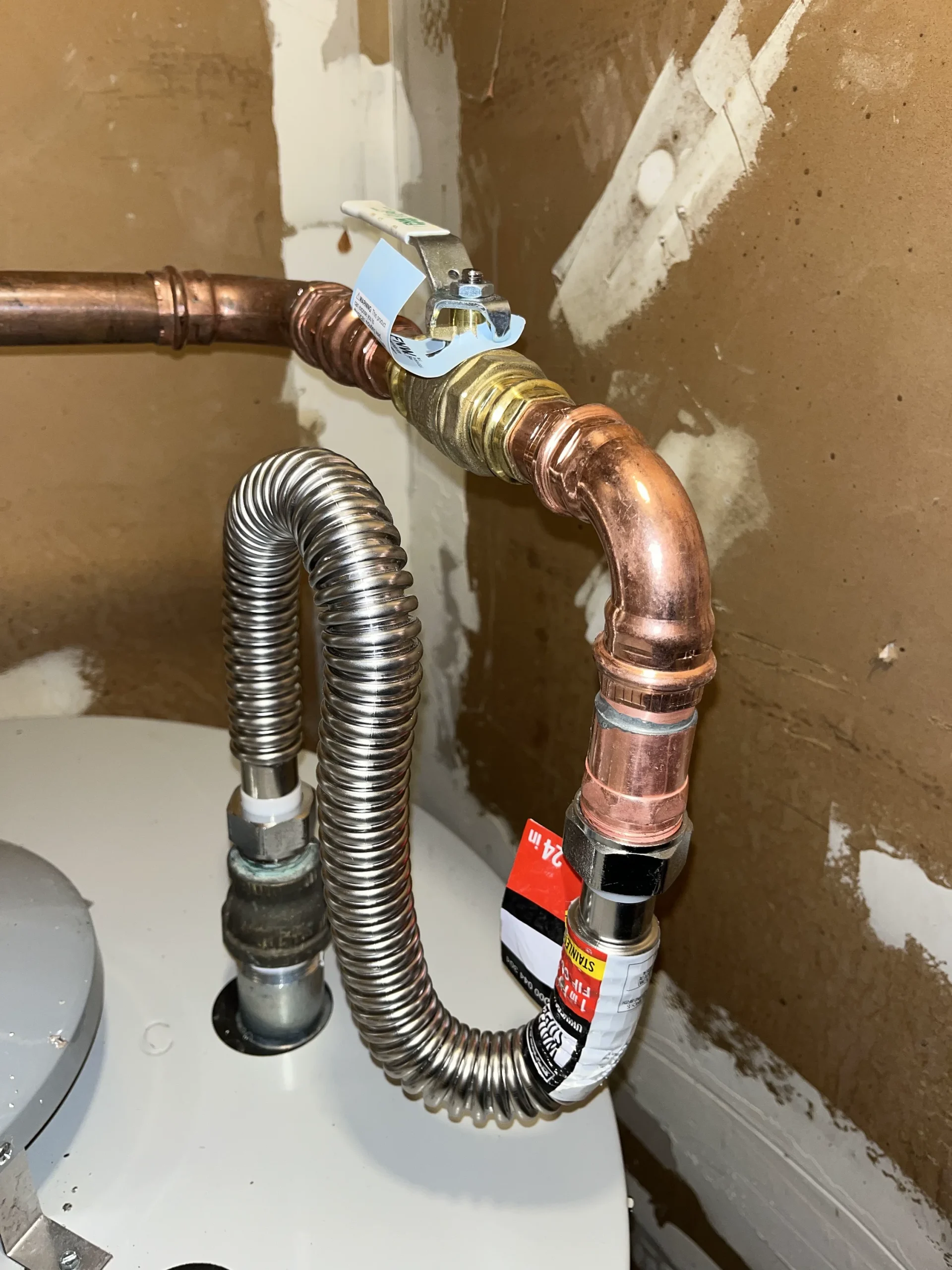 Fresh copper and flex connections on a Cupertino water heater.