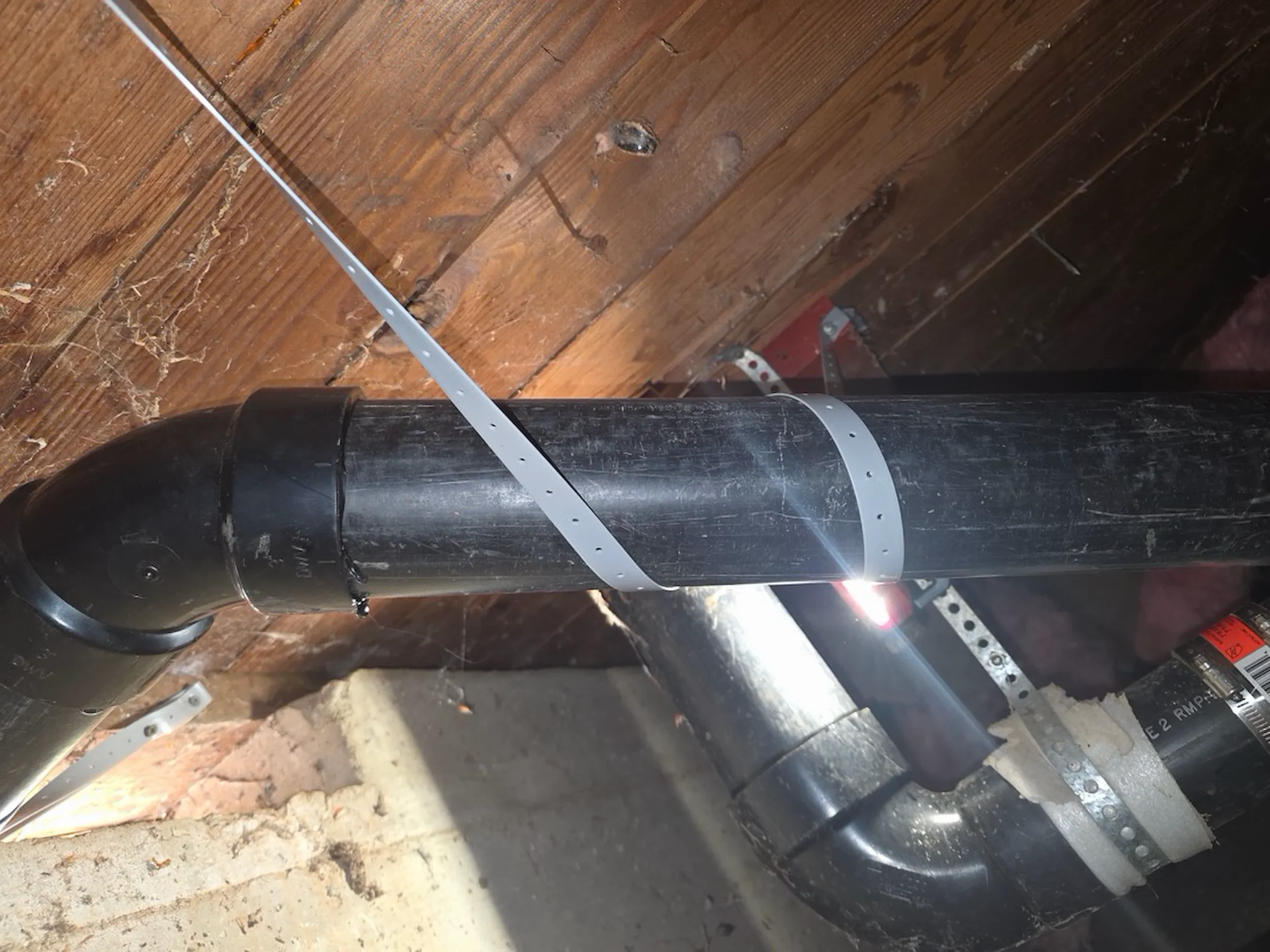 New drain piping strapped and secured under a South Bay home