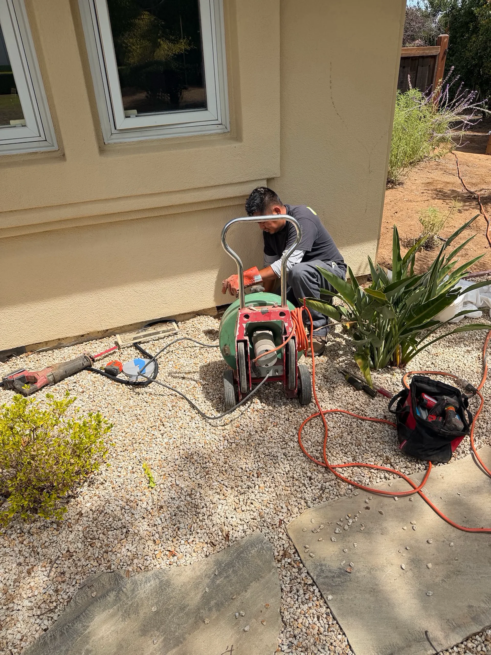 Simply Green Plumbing technician clearing a drain line at a Saratoga, California home